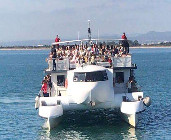 Friends enjoying the sea during a catamaran party in Valencia